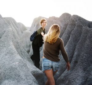 woman helping woman mountain